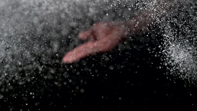 Man’s hand tossing flour. Slow Motion. 