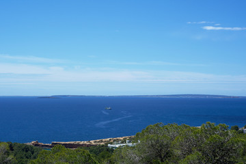 Sea coast with trees and cloudy sky. Ibiza island, Cala Roja, Spain