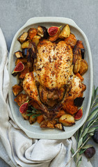 Roasted chicken with rosemary and  Sweet potato. served on grey stone, latin american food, top view