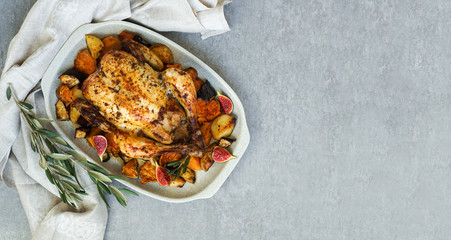 Roasted chicken with rosemary and  Sweet potato. served on grey stone, latin american food, top view