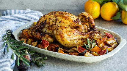Roasted chicken with rosemary and  Sweet potato. served on grey stone, latin american food, top view