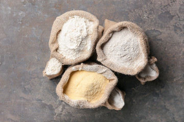 Bags with different flour on grunge background
