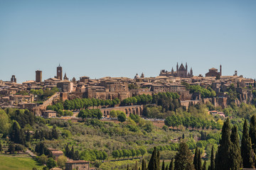Fototapeta na wymiar Panoramic view of Orvieto small vilage in Italy with red brick houses and towers and nature in Umbria Italy