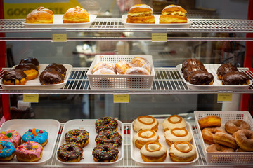 A selection of delicious sweet donuts for sale in a cafe in Christchurch city, New Zealand