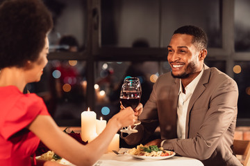 Spouses Clinking Red Wine Glasses Celebrating Anniversary In Fancy Restaurant