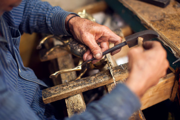 A man making embassed figure. Art and handwork industry