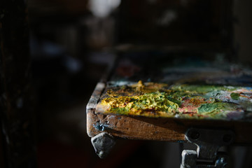 artist's palette with dried paint under the rays of the evening sun