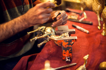 A man making embassed figure. Art and handwork industry
