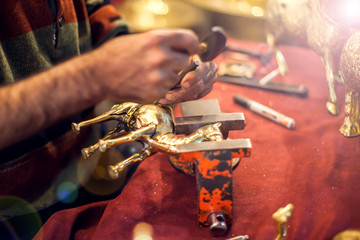 A man making embassed figure. Art and handwork industry