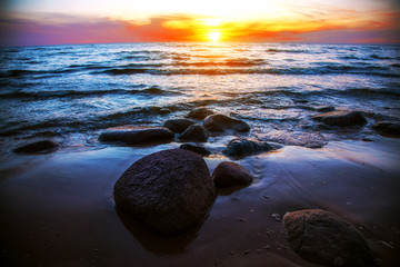 Fototapeta na wymiar Peaceful sunrise at sea with stones