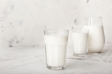 Glass of tasty milk on white background