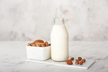 Bottle of tasty almond milk on white background