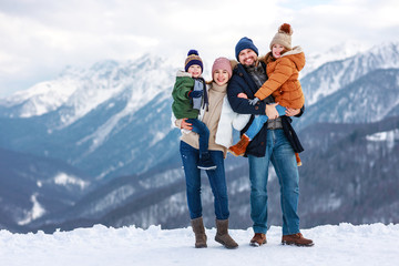 Fototapeta na wymiar happy family mother father and children on winter nature .