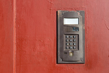 Fototapeta na wymiar an intercom on metall old door with a keypad for calling close up with copy space.