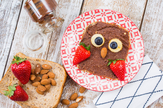 Fun food for kids. Sweet cream of almond, cocoa and date palm. Sandwich in the form of an owl