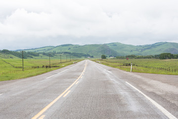 Fototapeta na wymiar two lane paved highway in the foothills of Alberta