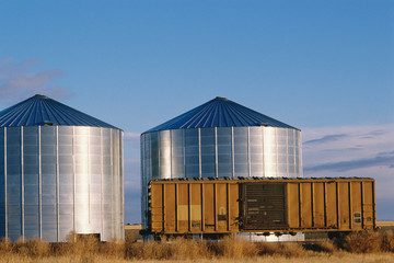 Railway car beside metal silos © spiritofamerica