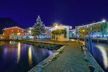 Christmas lights adorning the city center and Riva del Garda Street, View of the beautiful Riva del...