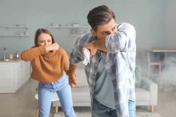 Young couple gasping at home because of fire