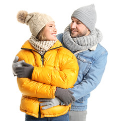 Portrait of happy couple in winter clothes on white background