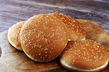 Buns with sesame. Fresh homemade burger buns on table.