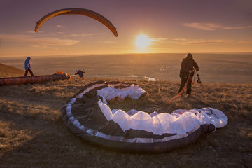 Paraglider during the flight in the sunlight