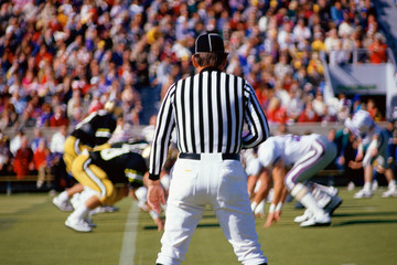 Referee watching football game