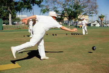 Man delivering ball in lawn bowling