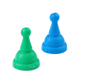 Green and blue figures for ludo family board game isolated on the white background. Copy space.