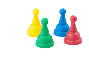 Colorful figures for ludo family board game isolated on the white background. Copy space.