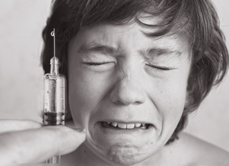 boy aftaid of vaccination injection