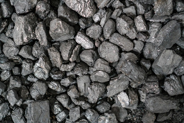 Char-coal. Pattern, heap. Pile of Bituminous Coal cinder. Stone coal Industry, business. Black coal mine close-up with soft focus. Anthracite coal bar