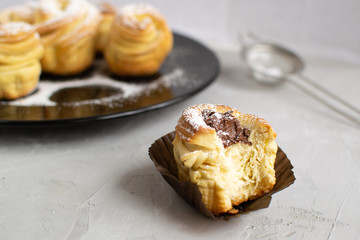Cruffins with nut paste filling on a grey background.