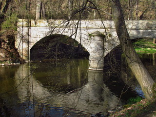 Fototapeta na wymiar Stone bridge on river Blanice, public park in city Vlasim, central bohemia region, landscape photo, Czech republic