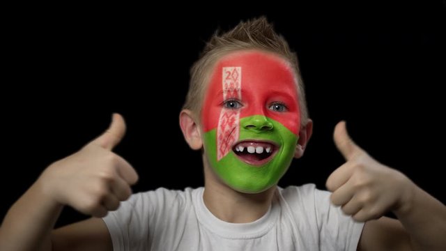 Happy boy rejoices victory of his favorite team of Belarus. A child with a face painted in national colors. Portrait of a happy young fan. Joyful emotions and gestures. Victory. Triumph.