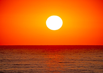 Fototapeta na wymiar big sun over sea