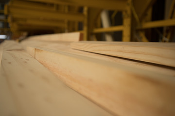 carpenter cutting plank with saw