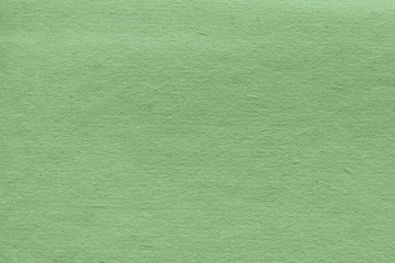 Cardboard green abstract pattern texture close-up. Retro old paper background. Grunge concrete wall. Vintage blank wallpaper.