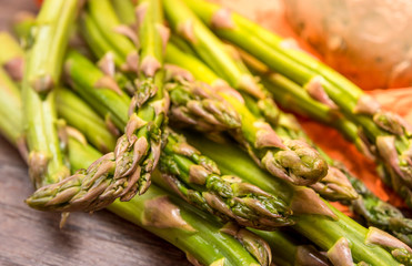 Green Asparagus (Asparagus officinalis) with bread on wooden table