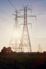 Fototapeta premium Silhouetted pylons and cables