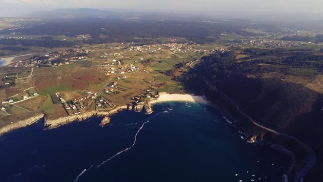 Beautiful sandy beach Barizo in Malpica, Spain. Aerial zoom out shot. Malpica landscape on a foggy day