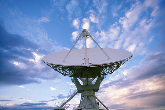 VLA Very Large Array radio telescope dish against clouds