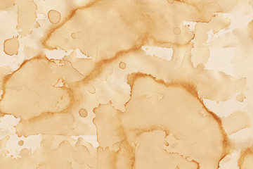 Fototapeta premium Vintage and old looking coffee cup stain background. Painted with a tea retro texture. Grunge paper for drawing. Ancient book page.
