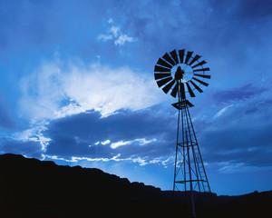 Windmill at dusk with cloudy sky