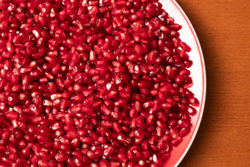 Pomegranate seeds in plate close up 