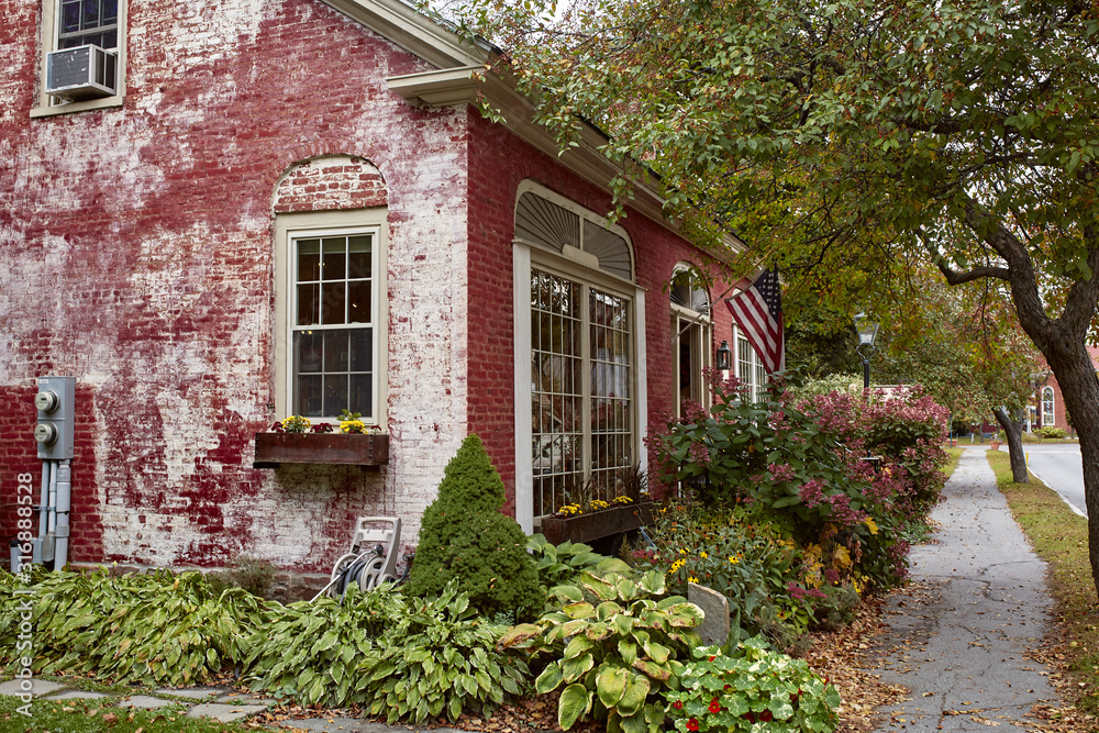 Wall mural Residential neighborhood with historic homes on a cool Fall day in the New England town of Woodstock, Vermont