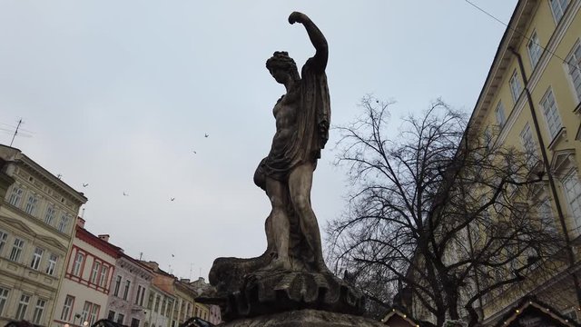 The fountain with the figure of Amphitrite. Statue of Amphitrite in Lviv Rynok market square. The sculptures represent one of the four Greek mythological figures. Ukraine.