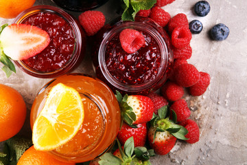 assortment of jams, seasonal berries jelly, mint and fruits and tangerine