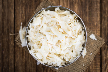 Portion of Coconut Chips as detailed close-up shot; selective focus