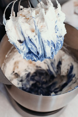 Cooking chocolate cream cupcakes. Confectioner cooks in kitchen.